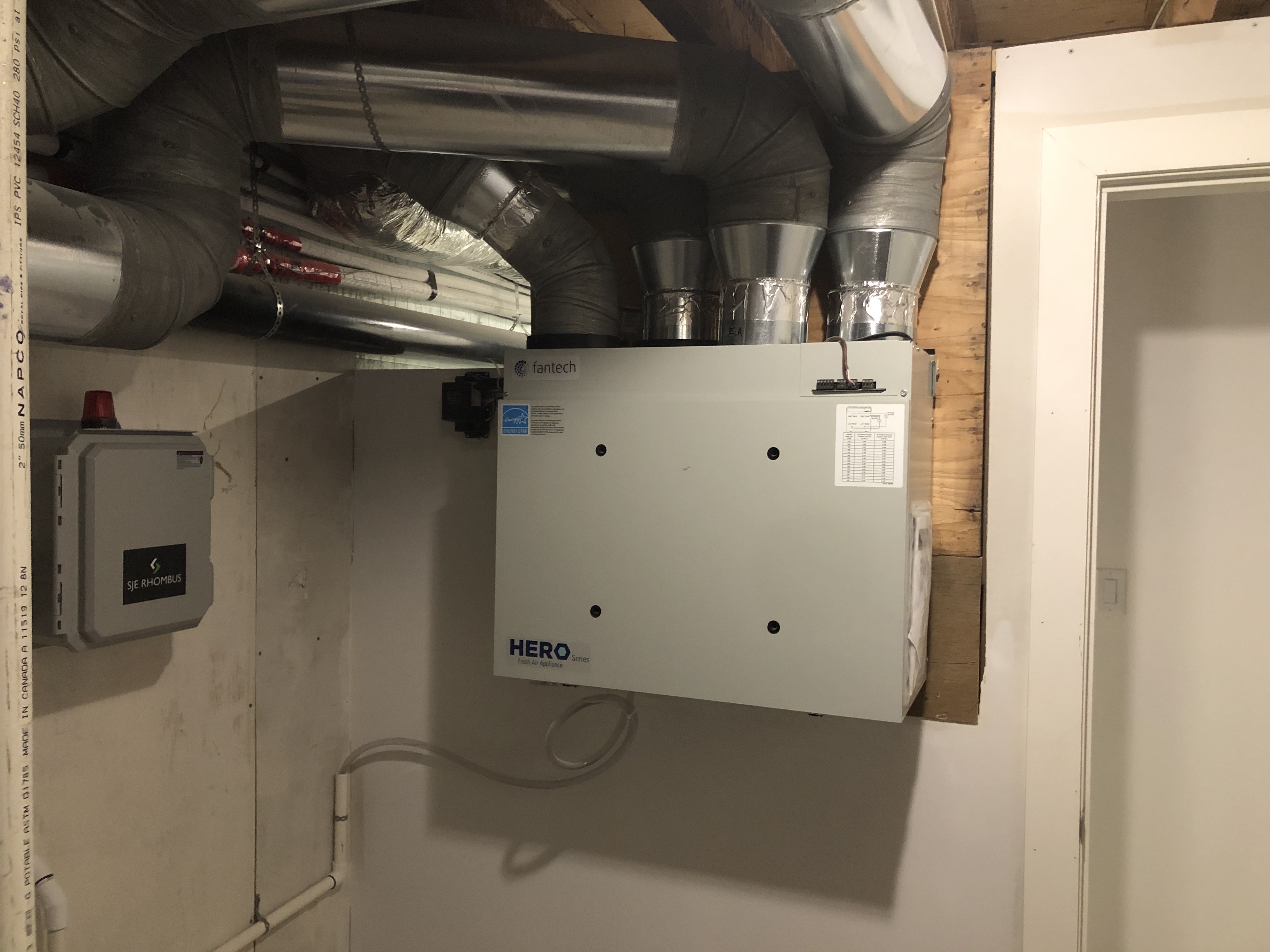 Fantech Hero HRV unit installed with ductwork in mechanical room